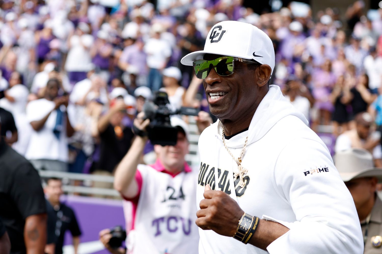 Colorado Buffaloes head coach Deon Sanders runs on the field before the game against the TCU Horned Frogs at Amon G. Carter Stadium